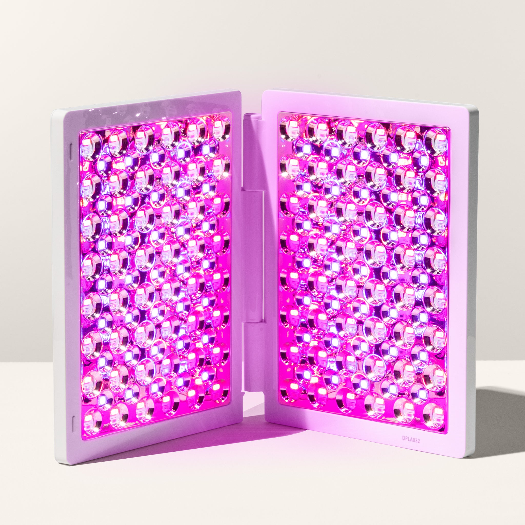 reVive Light Therapy LED panel glowing with red and near-infrared light